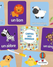 تحميل الصورة في عارض المعرض، Educational animal cards with French labels on a wooden surface
