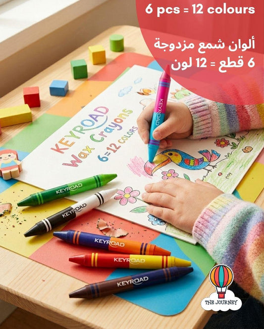Child coloring with KEYROAD crayons on a table with colorful paper and blocks.