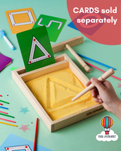 Load image into Gallery viewer, Sand tray with geometric lines and shapes and a hand using a tool, with &#39;The Journey&#39; branding.
